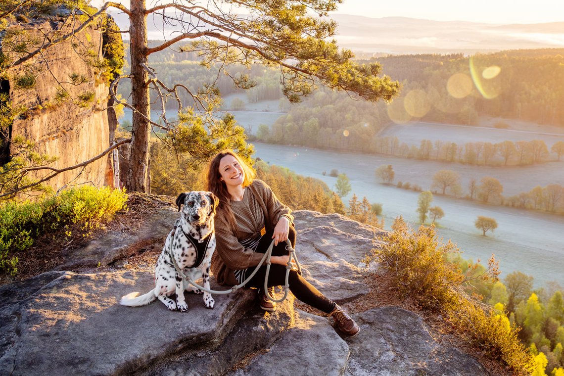 Hündin und Frauchen bei Sonnenaufgang in den Bergen Sächsische Schweiz